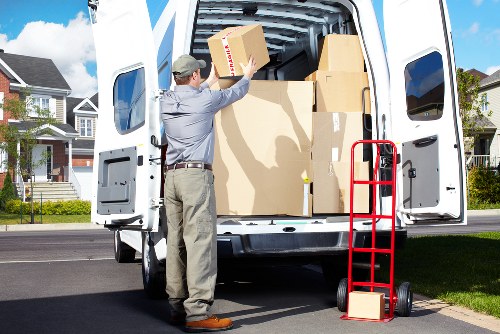 Local moving team loading boxes and furniture into a truck