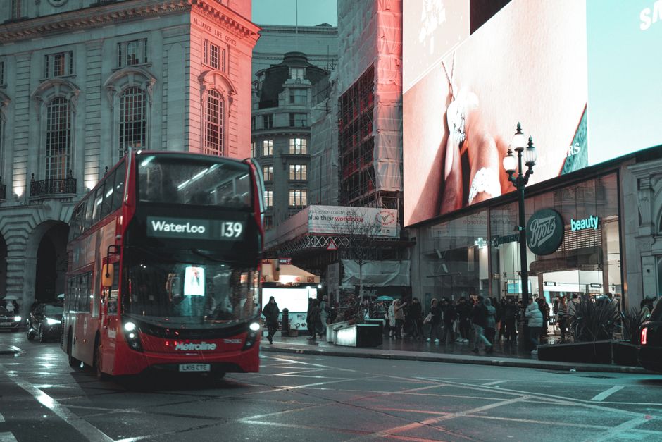 The image shows a busy urban street scene on St Thomas Street in Waterloo, with pedestrians walking along the sidewalk, some carrying shopping bags and others engaged in conversation. On the right sid